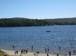 Visitors wading off the town beach into Schroon Lake. courtesy of Dougtone&nearr; (CC BY-SA 2.0&nearr;)