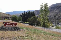 BLM entrance sign for Skookumchuck Recreation Site beside US-95, with the river at right. courtesy of BLMIdaho&nearr; (Public domain&nearr;)