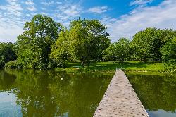 A dock reaching into Lake Macbride on a summer day, seen from the north side of the lake. courtesy of Tony Webster from Minneapolis, Minnesota, United States&nearr; (CC BY-SA 2.0&nearr;)