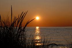 Sunset over Lake Michigan from the dune grass on the North Bar sand bar. courtesy of Jim Sorbie&nearr; (CC BY 2.0&nearr;)