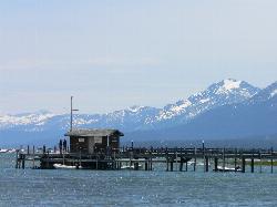View from Commons Beach across the water to a pier and the snow-capped mountains of the West Shore. courtesy of basykes&nearr; (CC BY 2.0&nearr;)
