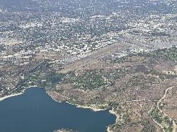 Aerial view of Puddingstone Reservoir and its shoreline, with Brackett Field airport beyond. courtesy of Platinummedia&nearr; (CC BY-SA 4.0&nearr;)