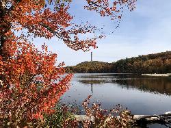 Autumn on Lake Marcia, with the beach at right and the monument on the hill. courtesy of Famartin&nearr; (CC BY-SA 4.0&nearr;)