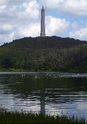 Swimmers inside the buoy line at Lake Marcia, with the High Point Monument above the lake. courtesy of Beyond My Ken&nearr; (CC BY-SA 4.0&nearr;)