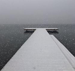 Snow falling on the Champlin Beach dock in November. courtesy of See1,Do1,Teach1&nearr; (CC BY 2.0&nearr;)
