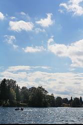 A small boat out on Horseshoe Lake under summer clouds. courtesy of return the sun&nearr; (CC BY 2.0&nearr;)