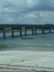 A picnic ramada under water at Governors Landing in July 2010, with the US 90 bridge across the Devi courtesy of homeronz&nearr; (CC BY-SA 3.0&nearr;)